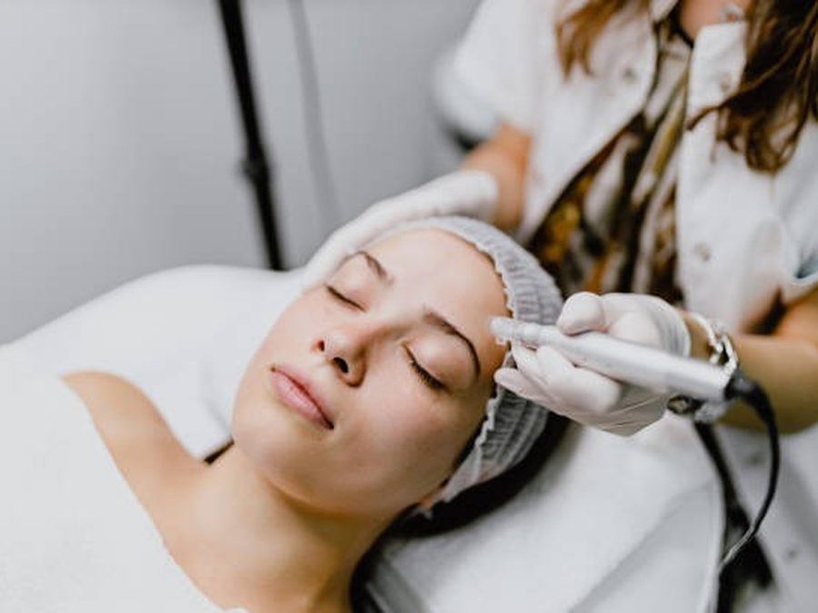 Hands applying cream during a facial