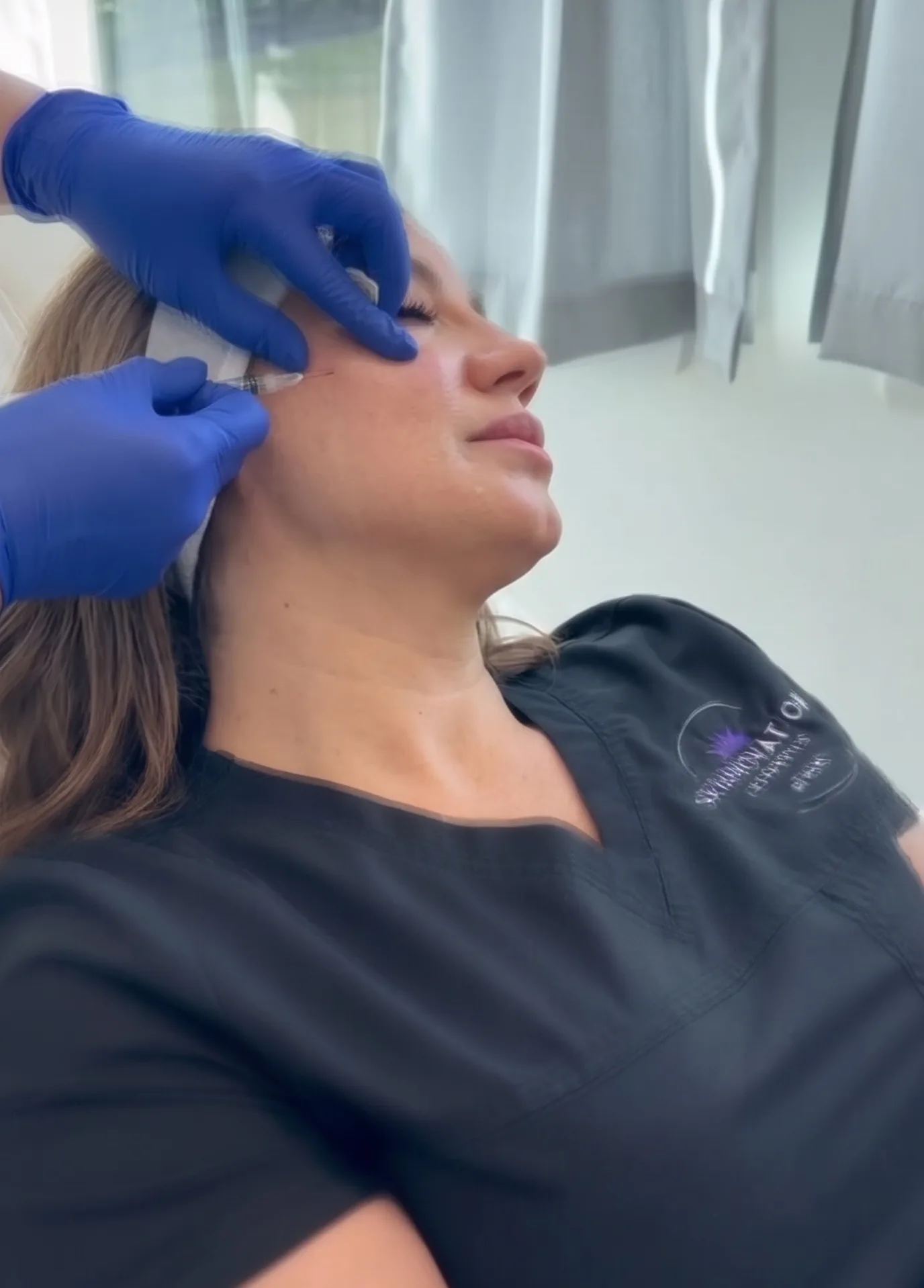 Skin rejuvenation facial treatment performed with gloved hands at Skinovation Aesthetics